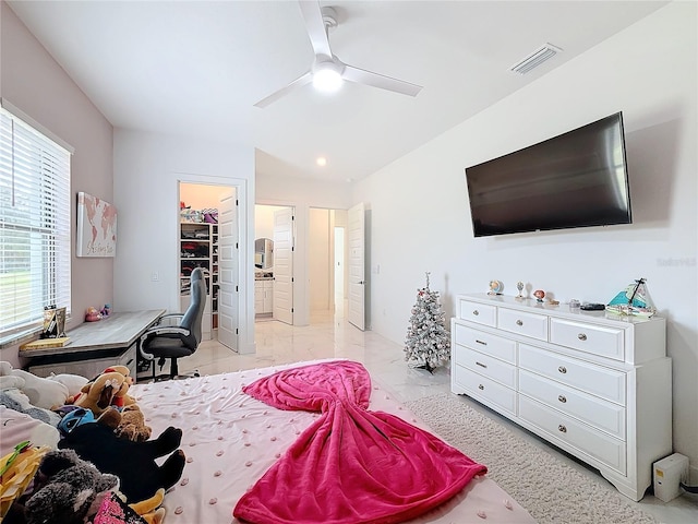 bedroom with ceiling fan, a closet, and a spacious closet