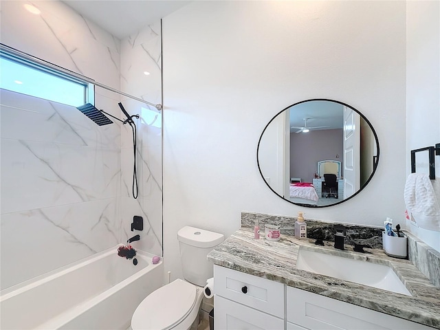 full bathroom with toilet, vanity, and tiled shower / bath