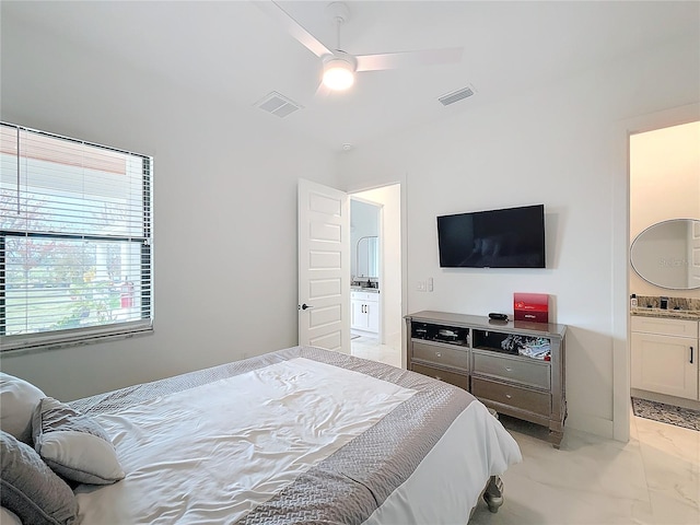 bedroom featuring ceiling fan and ensuite bathroom