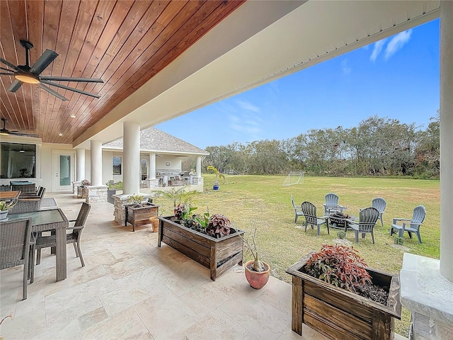 view of patio / terrace featuring ceiling fan and an outdoor fire pit