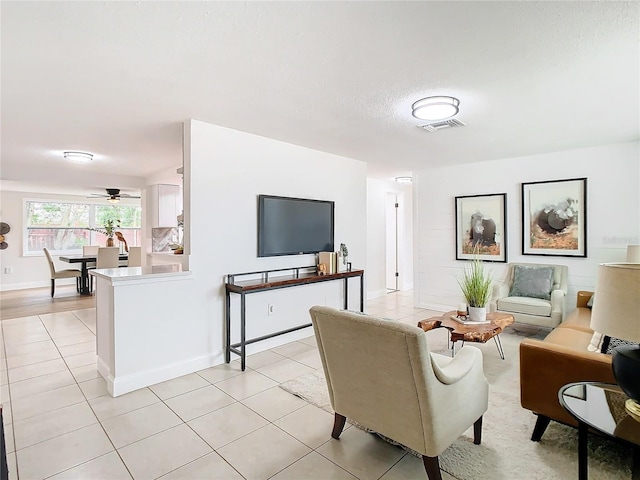 living room featuring ceiling fan and light tile patterned floors