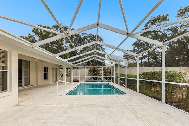 view of pool featuring a patio area and glass enclosure