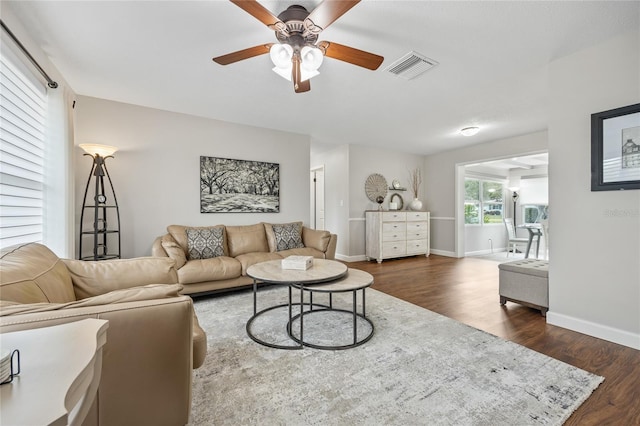 living room with ceiling fan and dark hardwood / wood-style floors