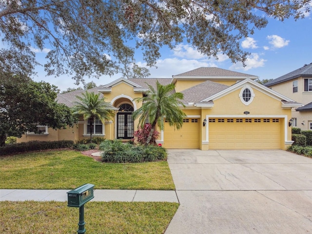 view of front of property with a front lawn and a garage