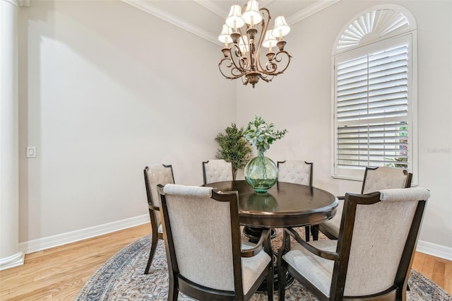 dining room featuring a notable chandelier, crown molding, and hardwood / wood-style flooring