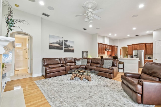 living room featuring ceiling fan and light hardwood / wood-style flooring