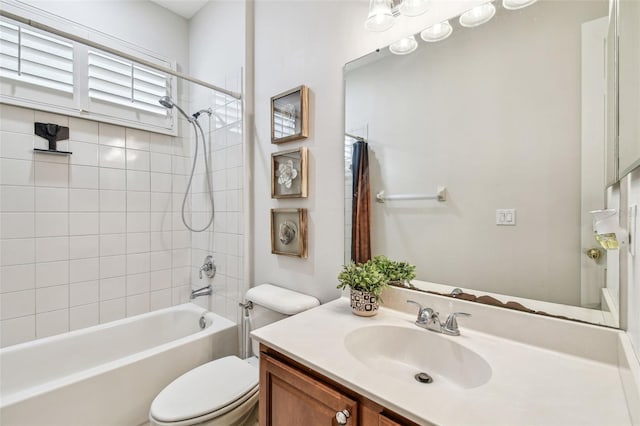 full bathroom featuring toilet, vanity, and tiled shower / bath combo