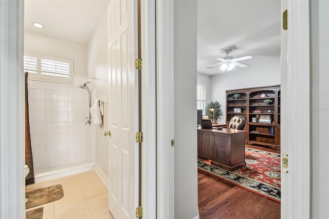 interior space featuring a healthy amount of sunlight, a tile shower, tile patterned floors, and ceiling fan