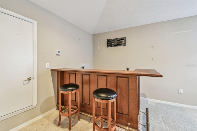 bar with light carpet and lofted ceiling