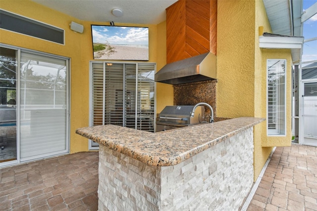 kitchen with wall chimney exhaust hood