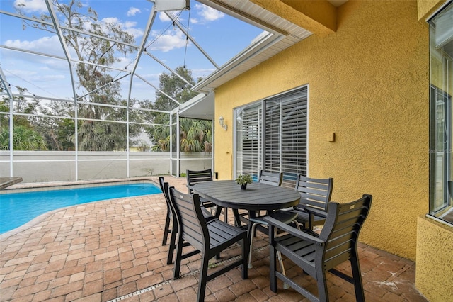 view of swimming pool featuring a lanai and a patio area