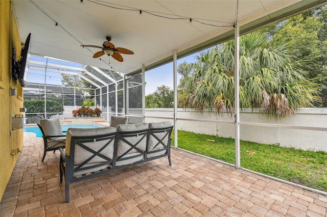 unfurnished sunroom with ceiling fan