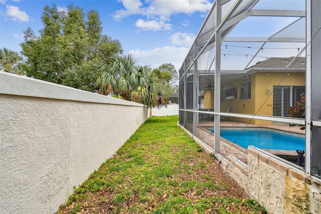 exterior space featuring a lanai and a lawn