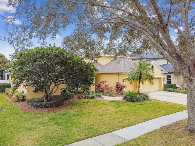 view of front of home featuring a garage and a front lawn