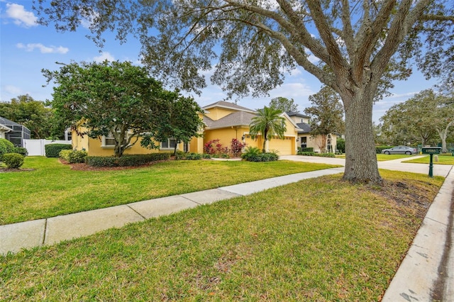 view of front facade with a garage and a front yard