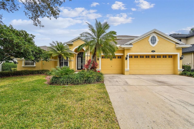 view of front of property with a garage and a front lawn