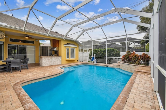 outdoor pool featuring a patio, a ceiling fan, a lanai, and outdoor dry bar