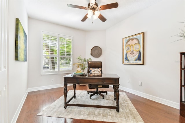 office space featuring baseboards, wood-type flooring, and ceiling fan