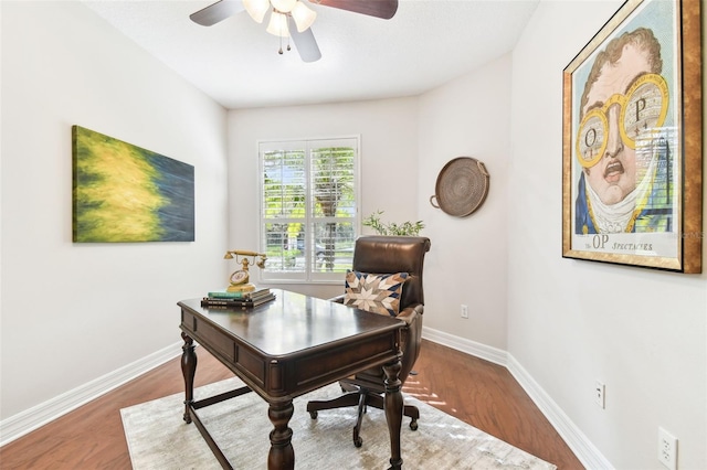 office with a ceiling fan, wood finished floors, and baseboards