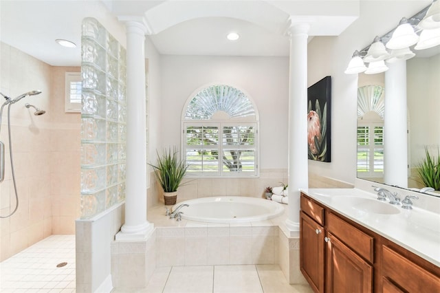 bathroom featuring vanity, ornate columns, a walk in shower, tile patterned floors, and a bath