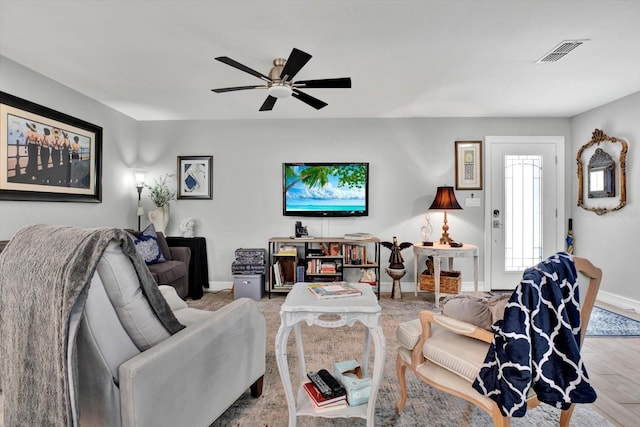 living room featuring ceiling fan and light hardwood / wood-style floors