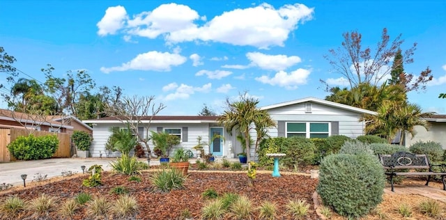 single story home featuring driveway and fence