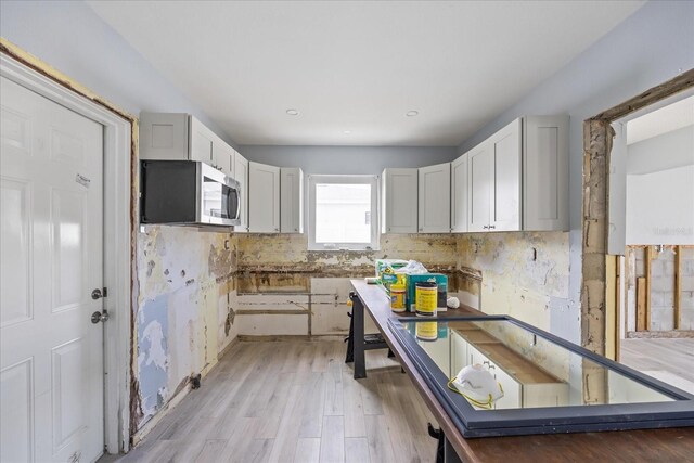 kitchen with white cabinets and light wood-type flooring