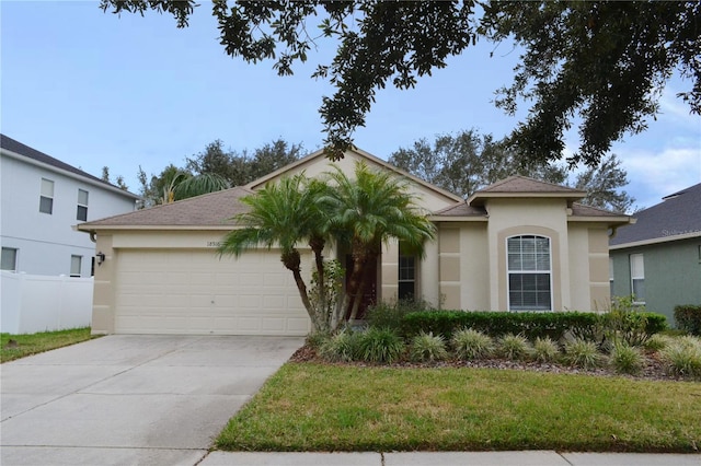 view of front of house featuring a front lawn and a garage