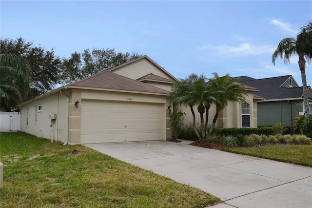 ranch-style home with a garage and a front yard