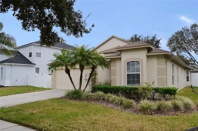 view of front of house featuring a front yard and a garage