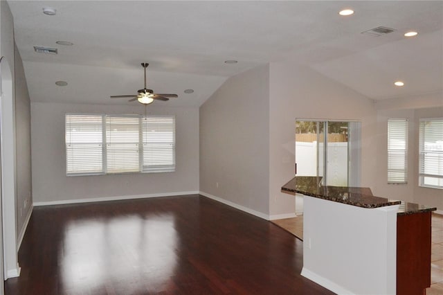 unfurnished living room featuring ceiling fan, dark hardwood / wood-style floors, and lofted ceiling