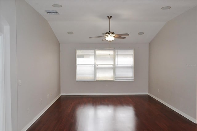 empty room with vaulted ceiling, ceiling fan, and dark wood-type flooring