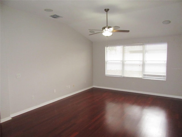 empty room featuring vaulted ceiling, ceiling fan, and dark hardwood / wood-style flooring