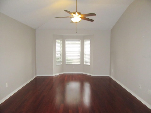 unfurnished room with vaulted ceiling, ceiling fan, and dark hardwood / wood-style flooring