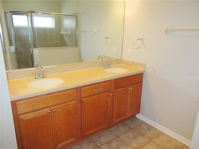 bathroom with a shower with shower door and vanity