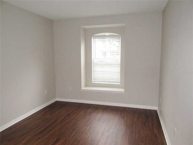 spare room featuring dark wood-type flooring