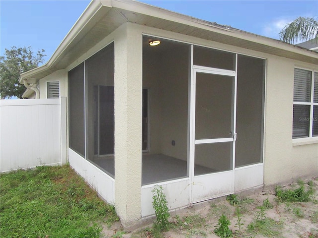 view of side of home with a sunroom