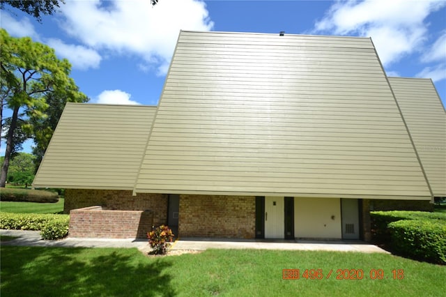 view of side of home with a lawn