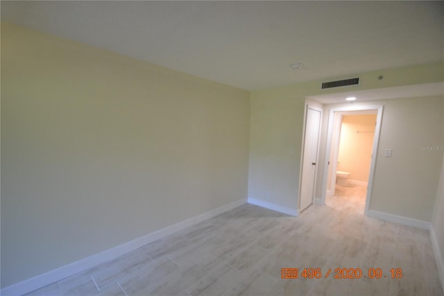 unfurnished room with light wood-type flooring