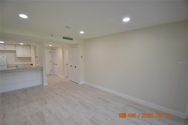 unfurnished living room with light hardwood / wood-style flooring