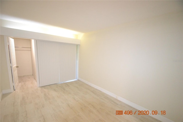 unfurnished bedroom featuring a closet and light hardwood / wood-style flooring