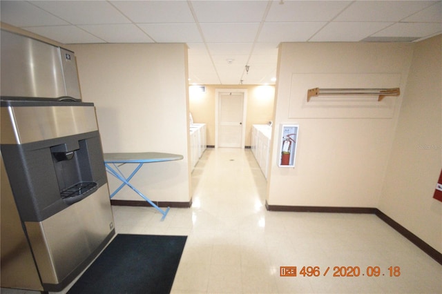 corridor with a paneled ceiling