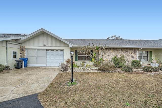 ranch-style home with a garage and a front yard