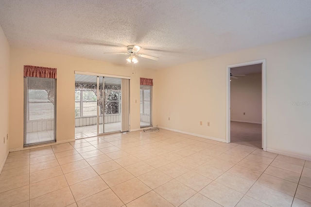 unfurnished room with ceiling fan, a textured ceiling, and light tile patterned floors