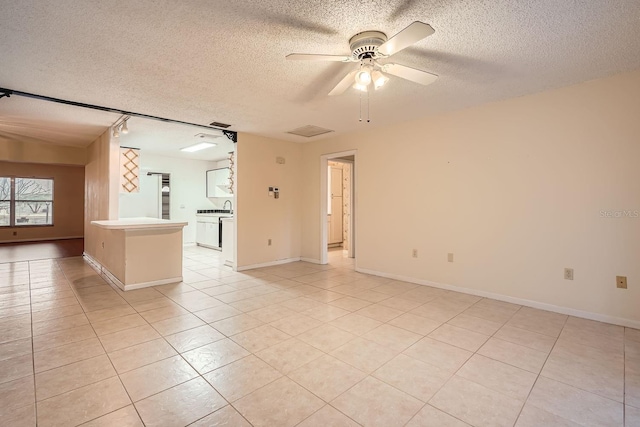 unfurnished room featuring ceiling fan, a textured ceiling, and light tile patterned flooring