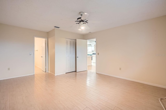 spare room featuring light wood-type flooring and ceiling fan