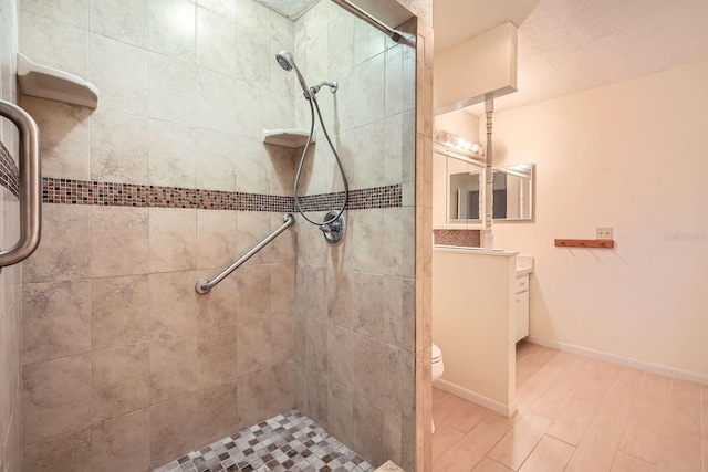 bathroom with a shower with door, toilet, and vanity