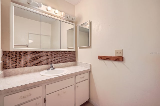 bathroom featuring decorative backsplash and vanity