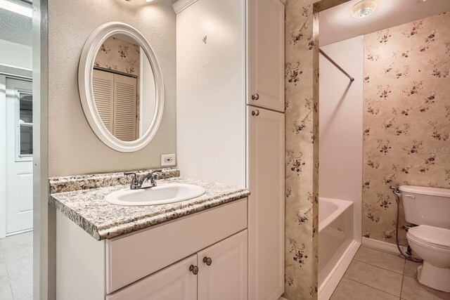 full bathroom featuring vanity, toilet, tub / shower combination, and tile patterned flooring