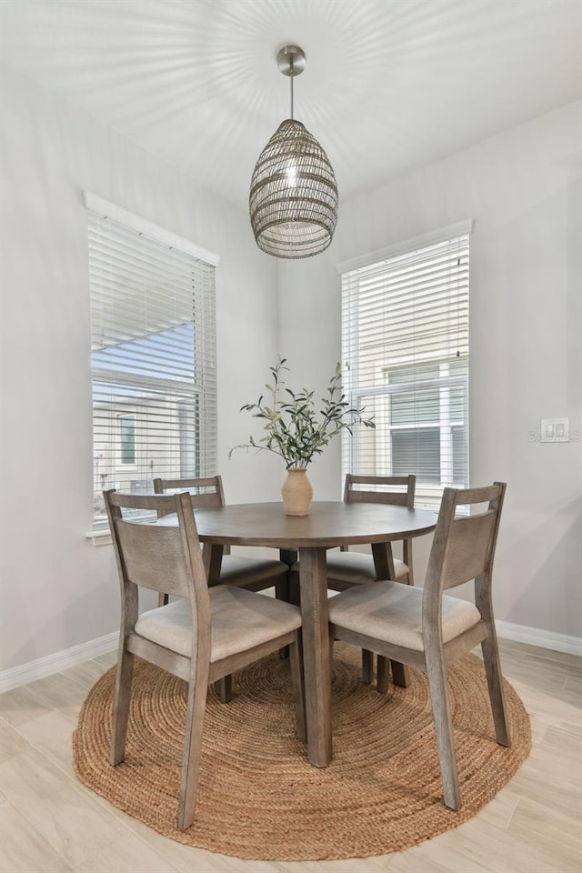 dining area with plenty of natural light and light hardwood / wood-style flooring